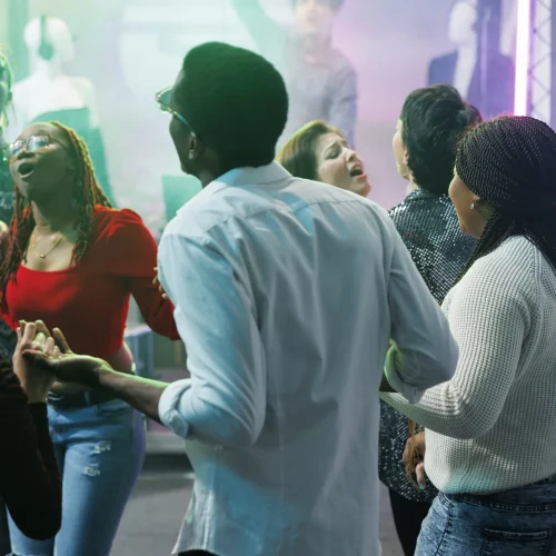 diverse-people-clubbing-dancing-together-discotheque-party-event-nightclub-young-friends-holding-hands-singing-relaxing-crowded-dancefloor-social-gathering